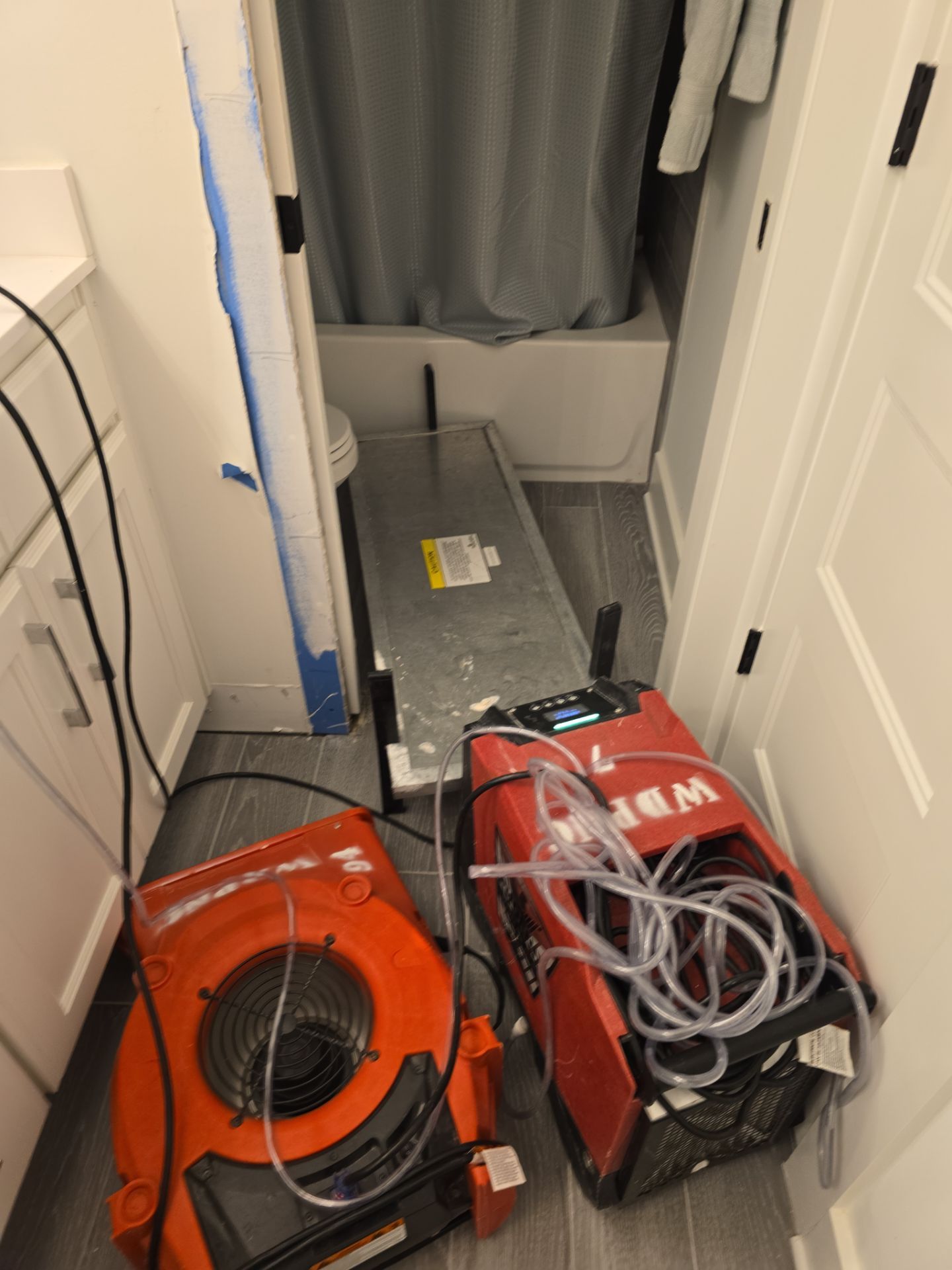 Can Flooring Be Saved After Water Damage In Fayetteville? 15 Water Damage Restoration In Raleigh Bathroom, Drying Equipment And Air Mover Set Up Near Tub After A Leak