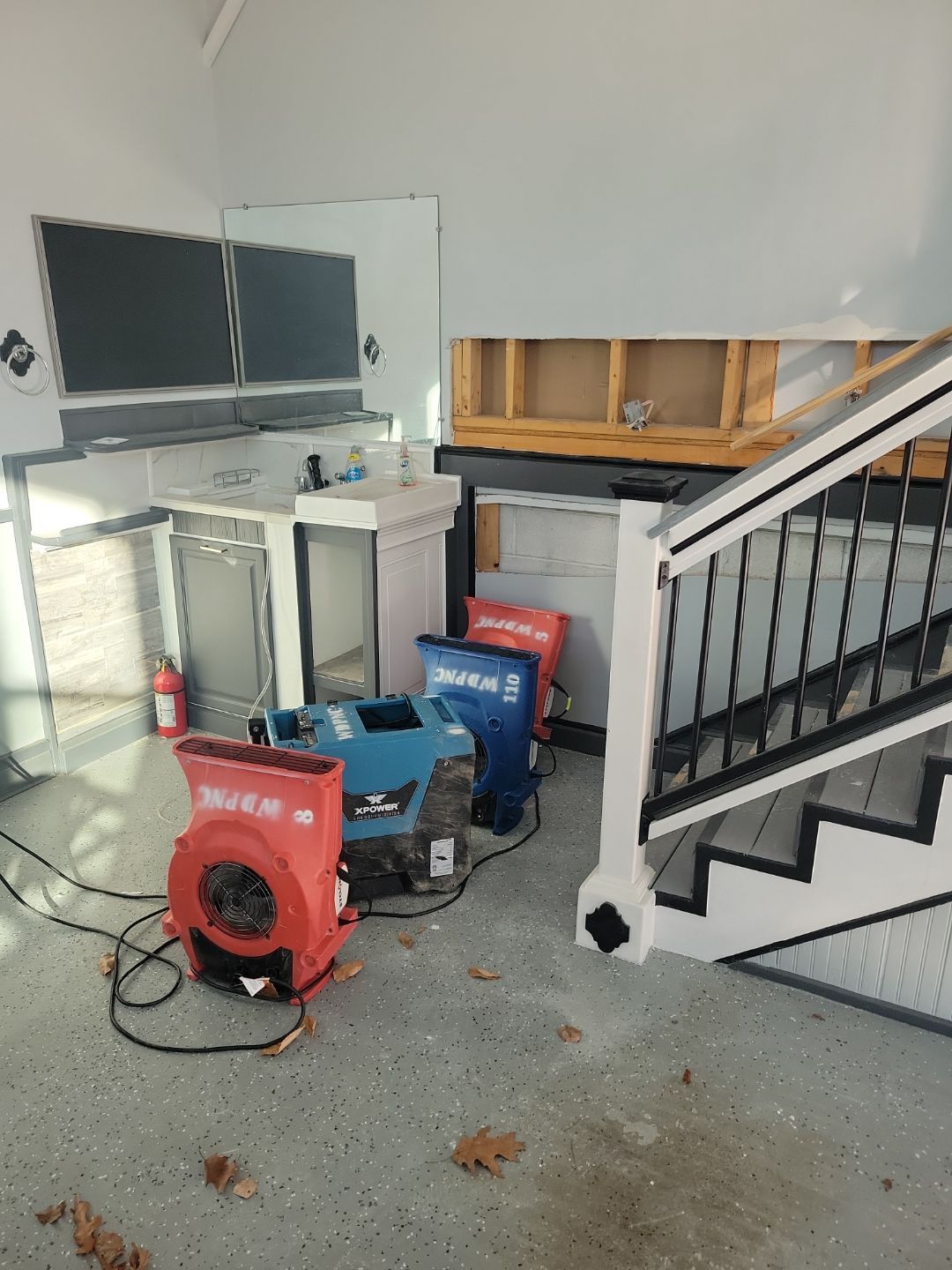 What Are The Warning Signs Of Hidden Water Damage After Heavy Rain? 11 Water Damage Restoration Drying Equipment Set Up In A Kitchen Area, With Air Movers And A Dehumidifier, And Sections Of Drywall Removed For Access And Structural Drying.